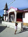 A little girl selling tomatoes at Gangga Satu, Sulawesi